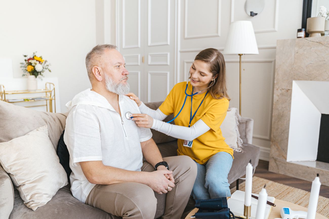 Carer conducting a home care visit with a senior client in their own living room