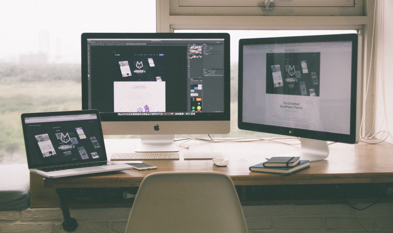 Multi-screen web design workspace with a live website layout in progress